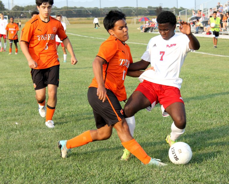 Jason Gil tries to poke the ball away from a Cardinal.