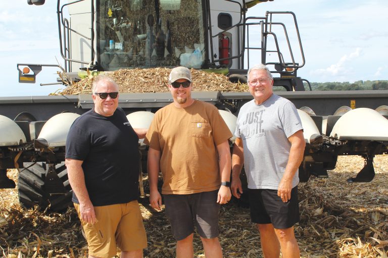Pictured above from left to right are Jon, Jared and Aaron Stock standing in front of one of their combines.