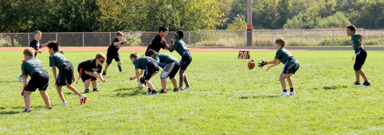 The running back makes a nice cut behind a great lead block during Beardstown JFL Flag Football action.