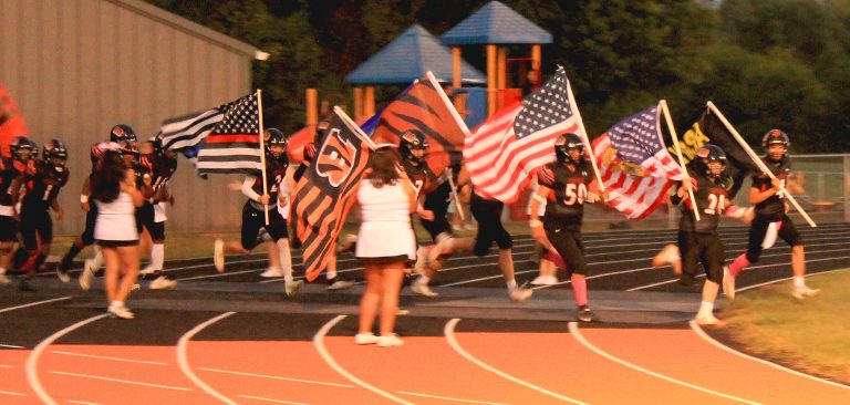 The Tiger captains lead the football team from the tunnel prior to the Brown County game.