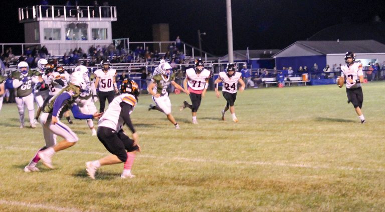 BHS quarterback Ethan Heller rolls out looking for Carter Davis in the flat in varsity action at North Greene.