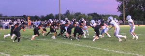 Quarterback Zach Meyer gets ready to hand off to fullback Gunner Looker on the opening play from scrimmage.