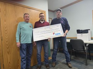 Shown from left are: Ashland Fire Protection District board President Garrett Savage, Evan Marr of Cass-Morgan Farm Bureau, Ashland Fire Protection District Chief Shane Hall. Photo by Michael Kloppenburg