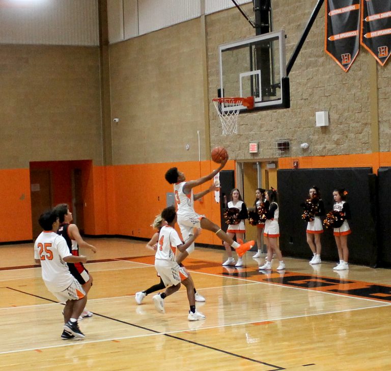 Dewade Gaffney goes high for the breakaway layup for Beardstown’s eighth graders.