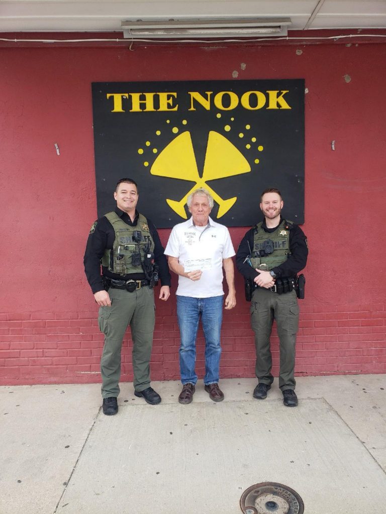 On Friday November 15, The Nook Lounge held a “Celebrity Bartender Fundraiser” for the Shop With A Cop organization. Volunteers from local businesses along with citizens all pitched in to bartend for the evening. Pictured is Doug Birdsley (center) giving a check to Terry Comiskey (left) and Sam Reller (right) in the amount of $2,275.00. A big thanks to all volunteers for this good cause.