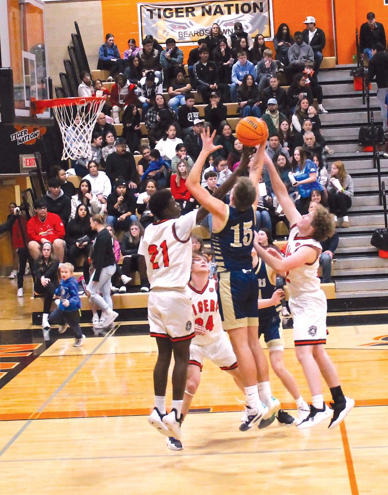 This rebound is up for grabs in varsity basketball action against Quincy Notre Dame.