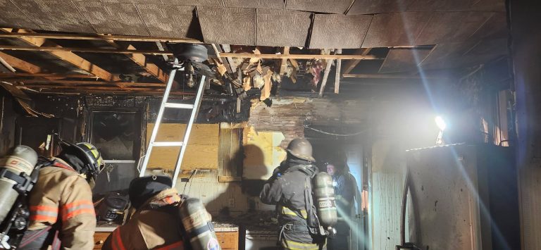 Firefighters work in the kitchen during a house fire December 24. Photo Beardstown Volunteer Fire Department Facebook