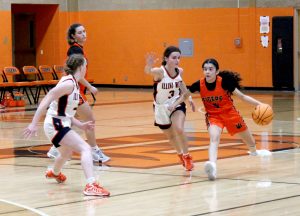 Lady Tiger point guard Camila Salazar brings the ball up against some pressure defense. Photo by Jason Brockschmidt