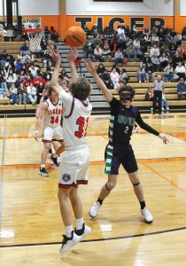 The Tiger’s Zach Meyer launches a three-pointer from the corner.