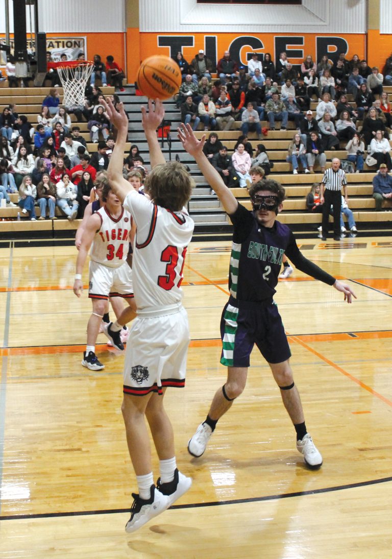 The Tiger’s Zach Meyer launches a three-pointer from the corner.