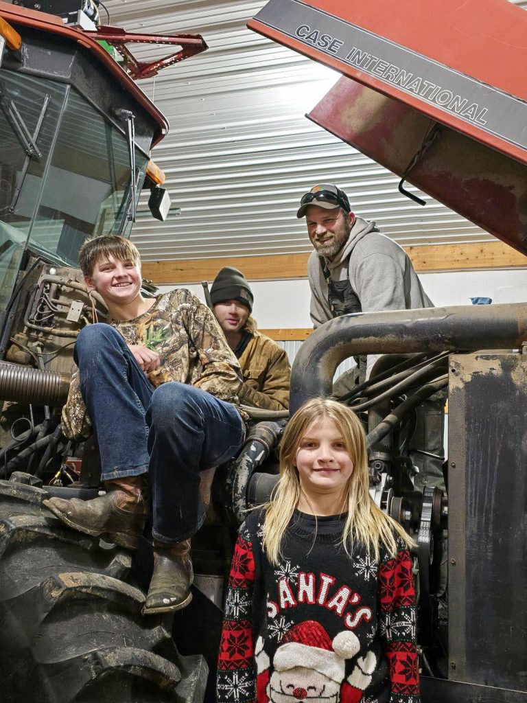 Zach Taylor poses on the farm with his kids, Nathan, Mitchell and Natalie. Taylor, a military veteran, applies his experience and discipline to implement safety measures on the farm, ensuring a secure environment for his family and operation. Photo courtesy of Zach Taylor