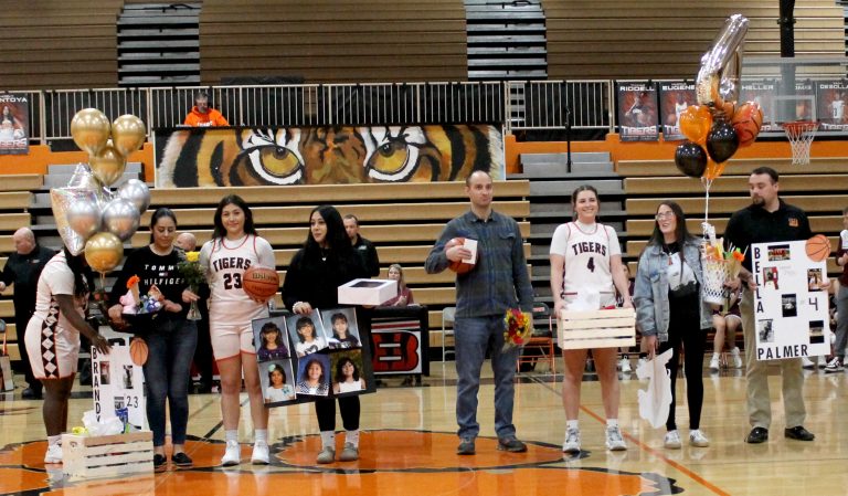 Senior BHS basketball players Brandy Mendoza (#23) and Bella Palmer (#4) are pictured with their families prior to the Senior Night game against Mendon Unity.