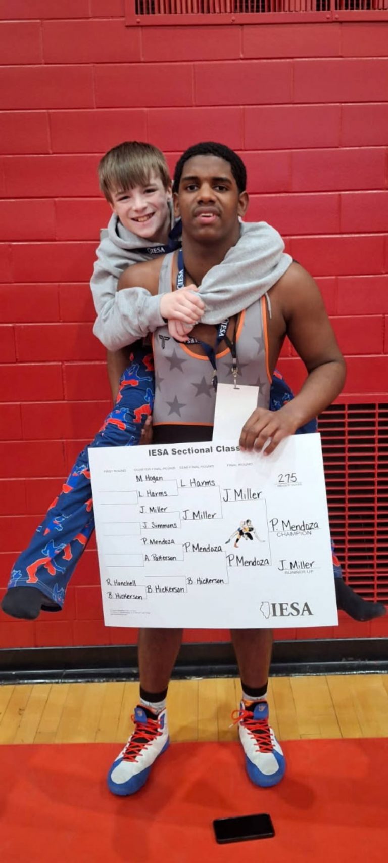 ude Dawson (left) and Pedro Mendoza ham it up after qualifying for the IESA State Wrestling Tournament. Mendoza was Sectional Champ at 275 pounds and Dawson took third at 80 pounds.